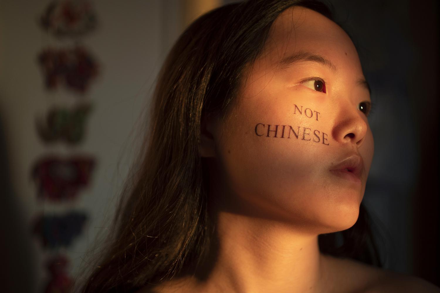 portrait of the artist with the words "not chinese" written on her right cheek